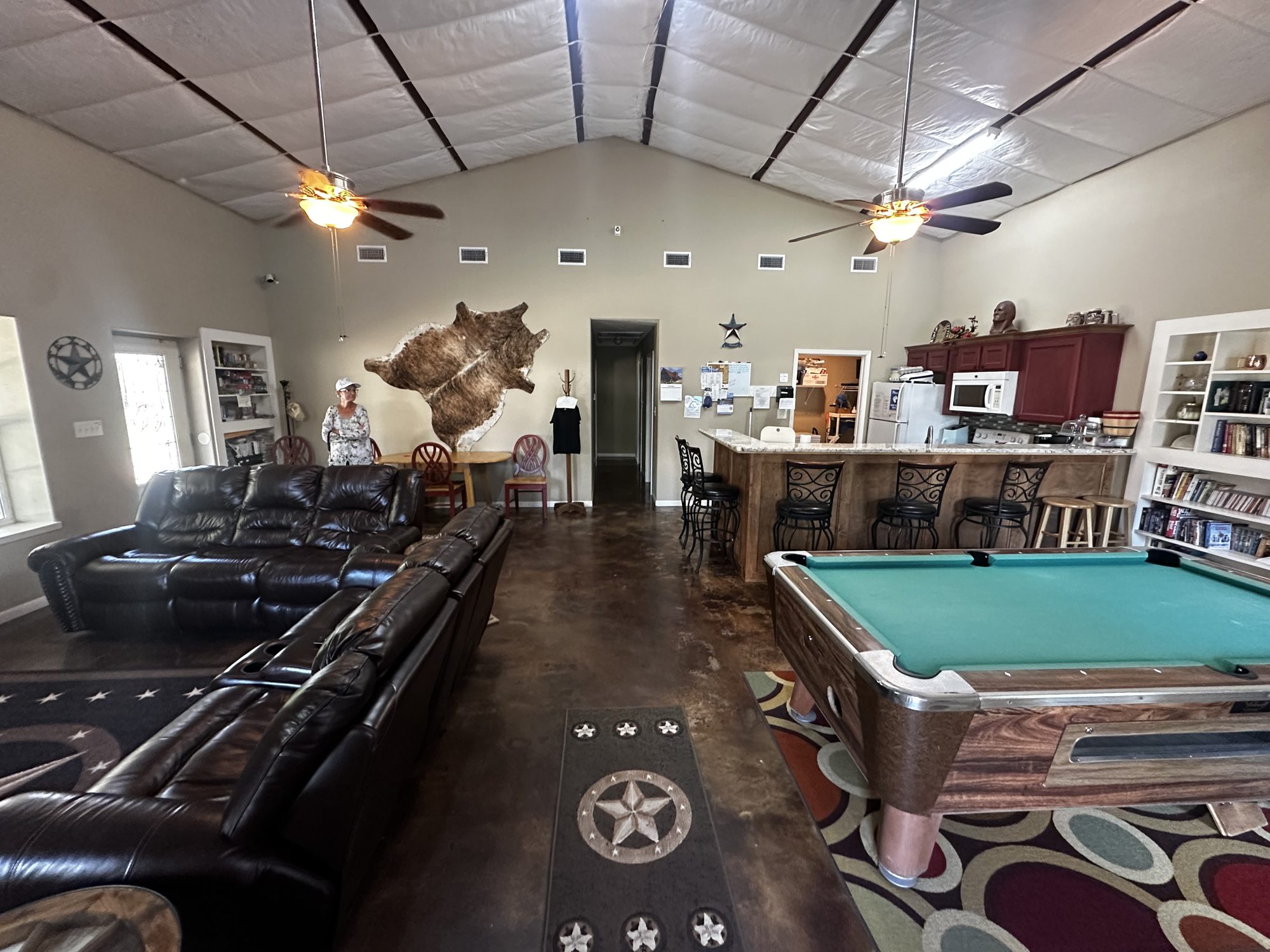 Clubhouse interior with pool table, leather sofas and kitchen bar