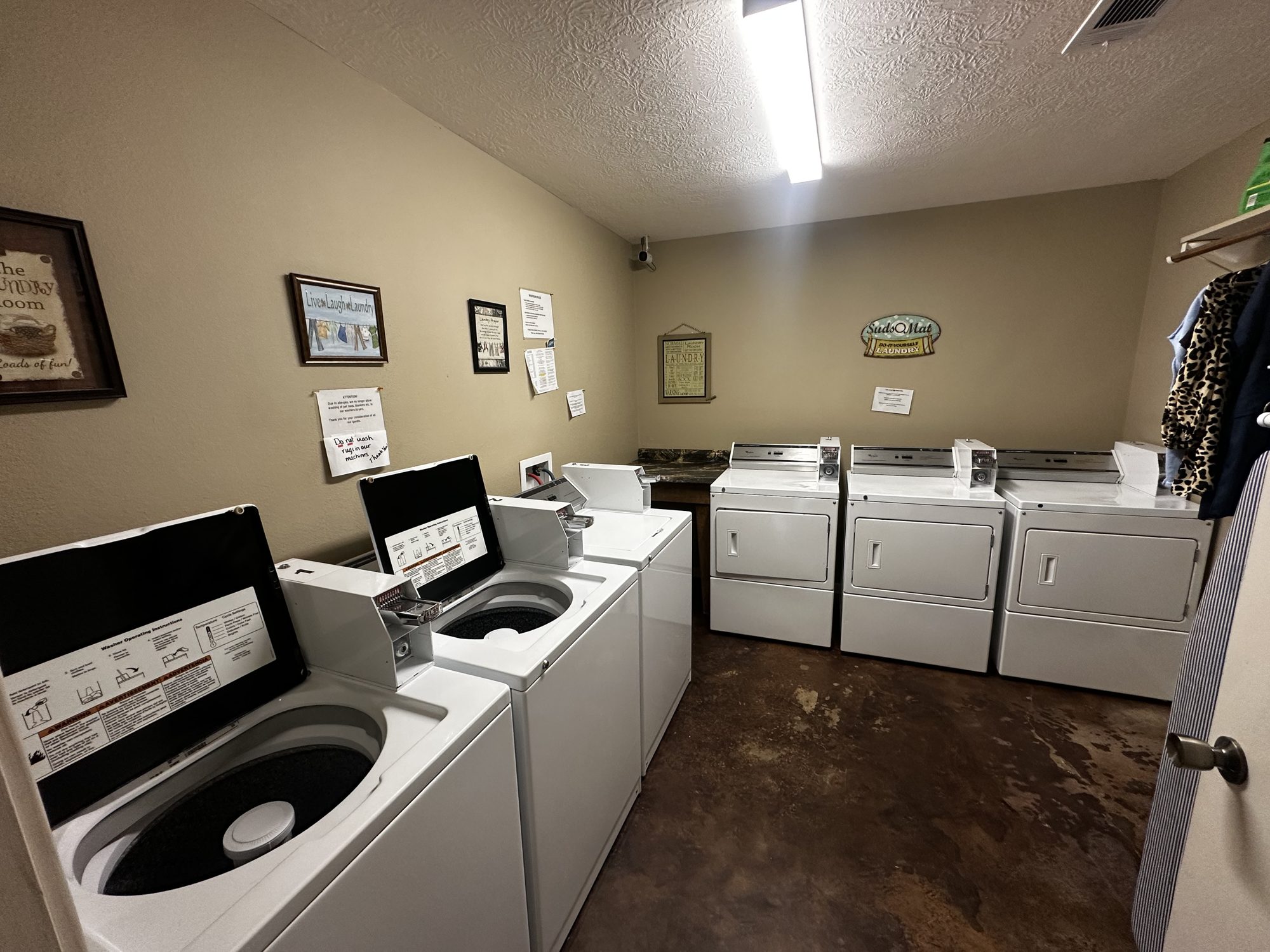 Laundry room with multiple washers and dryers