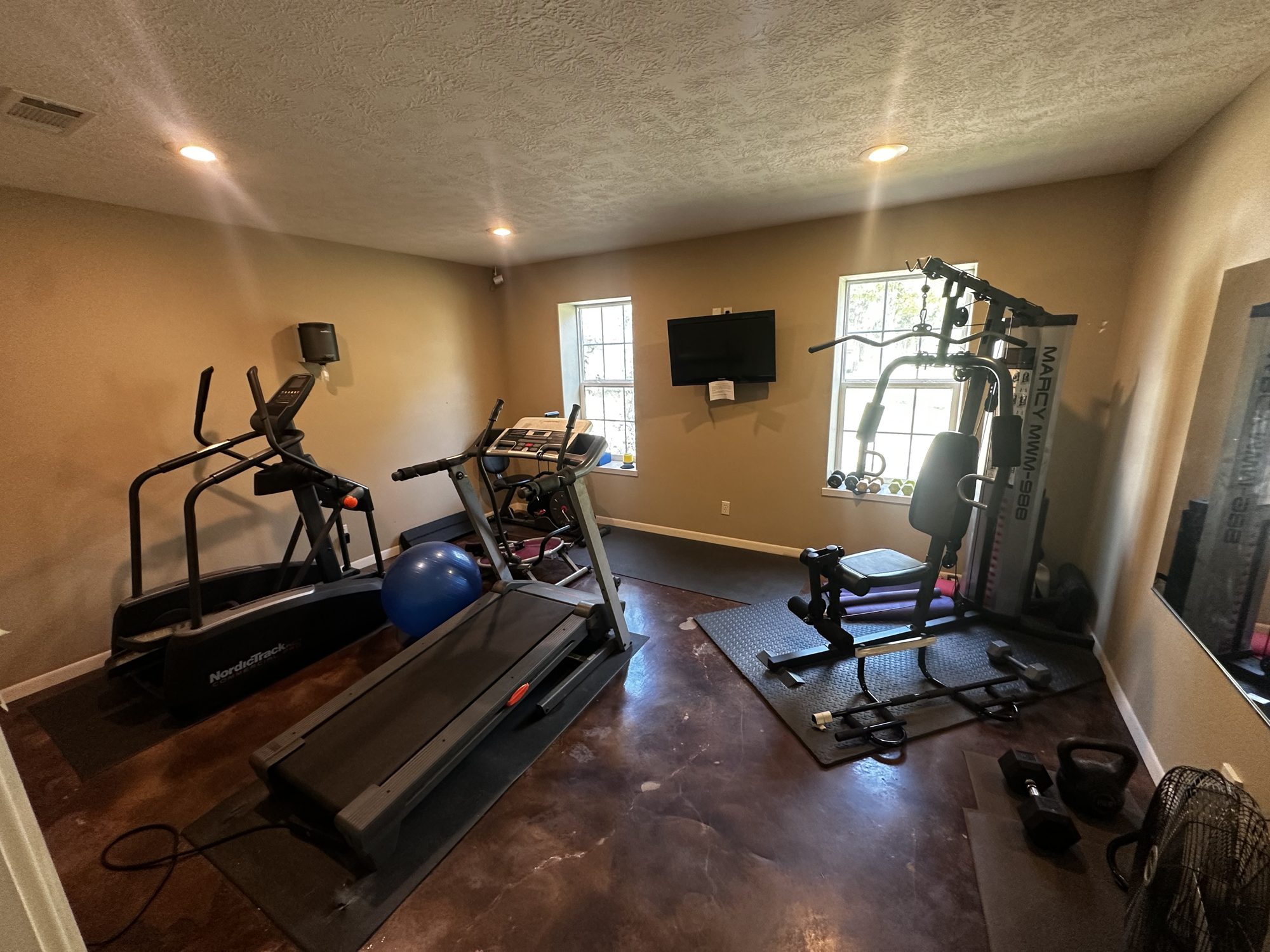 Fitness room with treadmill, elliptical and weight machine